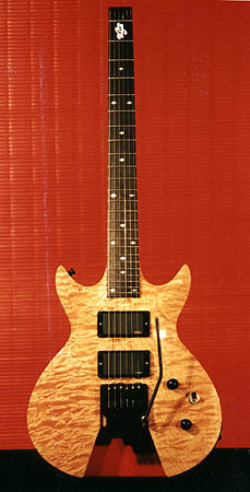 Headless guitar with quilted maple top and Trem.